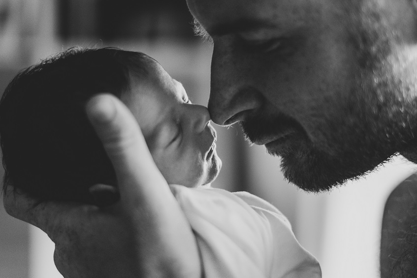 close up father touching baby with his nose