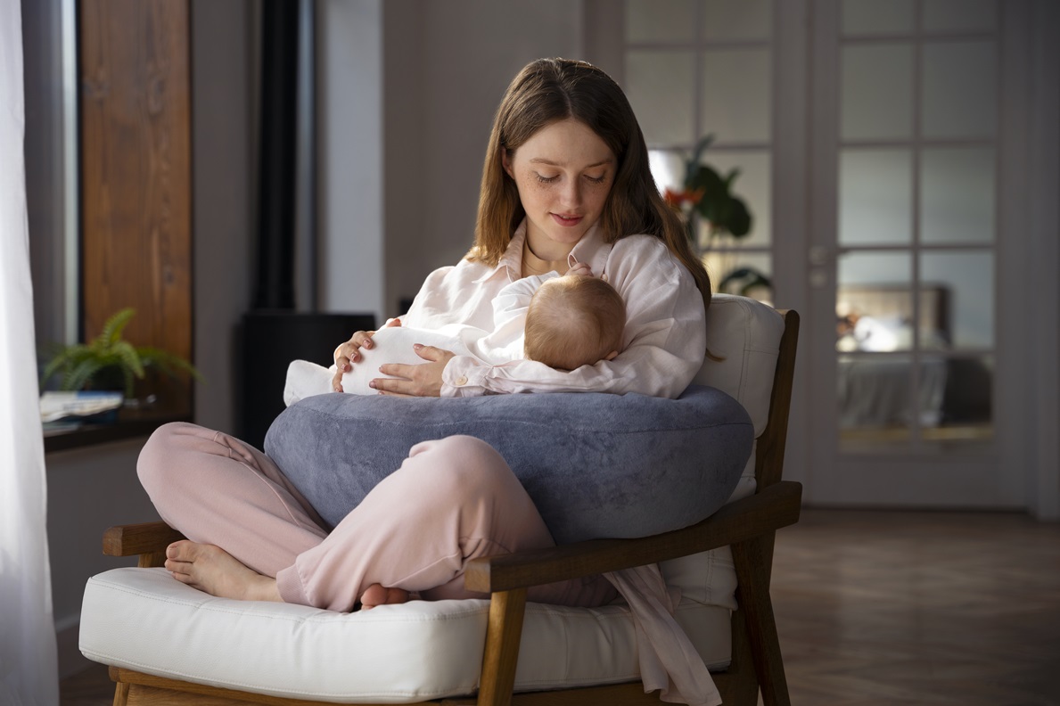 woman using nursing pillow home newborn baby