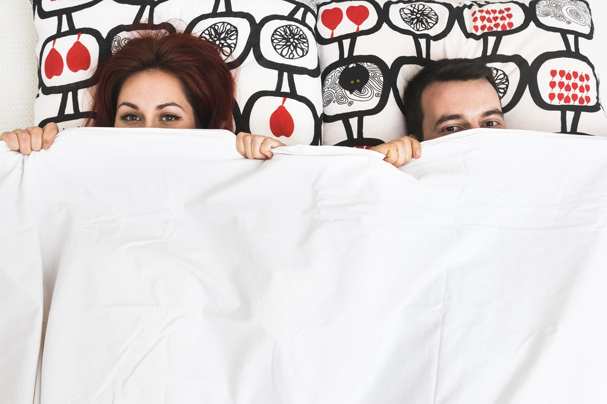 couple hiding their face blanket