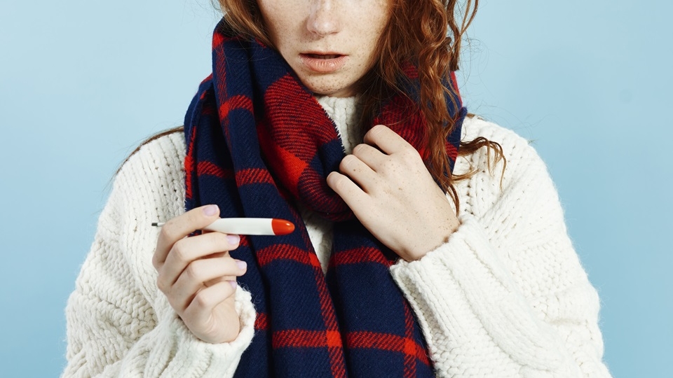 shocked woman with digital thermometer checking temperature