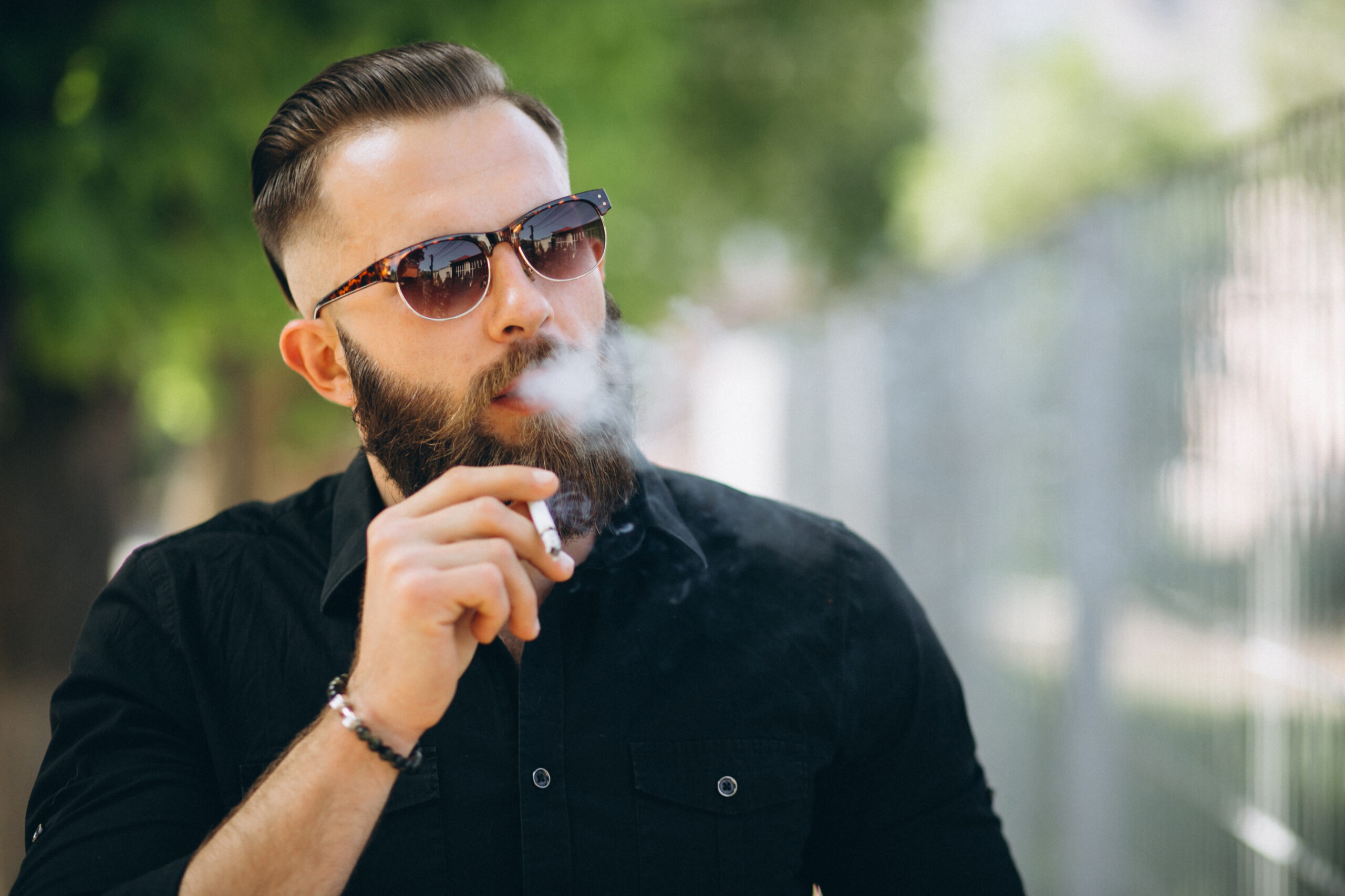 bearded man smoking cigarette